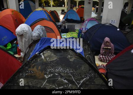 Bandung, Indonesia. 12th Apr, 2023. A Muslim woman performing night prayers 'Itikaf' among the tents of devotees during the holy month of Ramadan at the Habiburrahman mosque in Bandung, West Java, Indonesia on April 12, 2023. On the last ten nights of Ramadan 1444 Hijri, Muslims perform Itikaf to reach the night of glory (Lailatul Qadar) by reading the Koran, night prayers and remembrance. (Photo by Dimas Rachmatsyah/INA Photo Agency/Sipa USA) Credit: Sipa USA/Alamy Live News Stock Photo