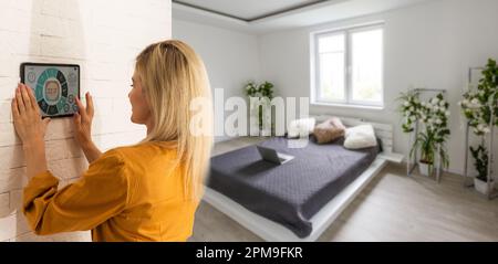 Woman using smart wall home control system Stock Photo