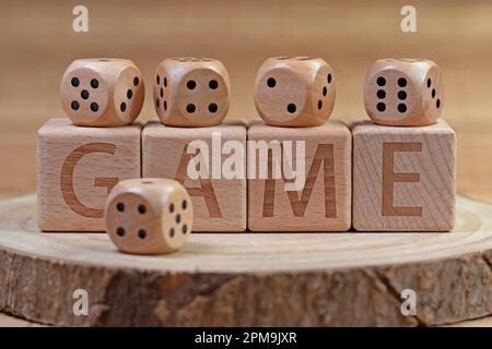 Wooden dice with the imprint "Game" Stock Photo
