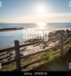 Cornish sandy beach at sunset with breaking waved in the background Stock Photo