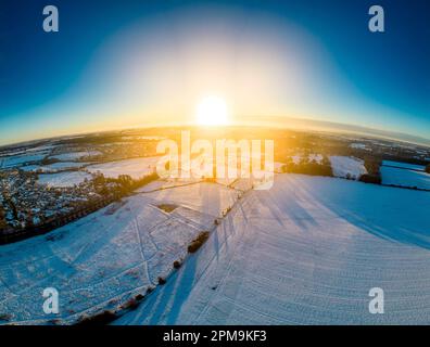 Panoramic landscape looking towards Cirencester in the cotswolds at sunrise with the snow. Stitched from multiple photographs. Stock Photo