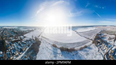 Panoramic landscape looking towards Cirencester in the cotswolds at sunrise with the snow. Stitched from multiple photographs. Stock Photo