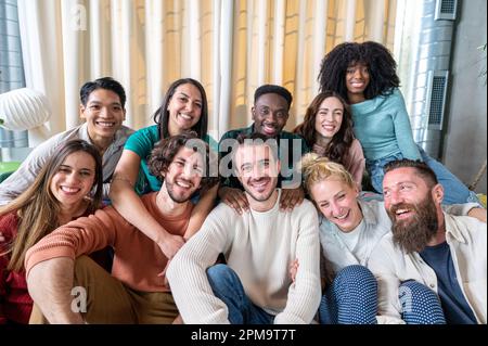 Portrait of a large group of young people at home Stock Photo