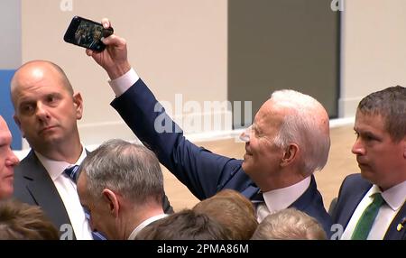 US President Joe Biden takes a selfie with guests after his speach at Ulster University in Belfast, Northern Ireland, Wednesday, April 12, 2023. President Biden's visit marks the 25th anniversary of the Good Friday Agreement, the peace deal which ended three decades of conflict in Northern Ireland. Photo by Ulster University/UPI Credit: UPI/Alamy Live News Stock Photo