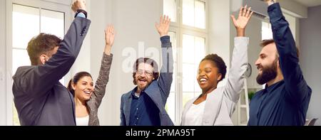 Happy business team determined and enthusiastic about their work celebrates good result. Stock Photo