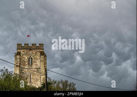 Orwell,  Cambridgeshire, UK. 12th Apr, 2023. Mammatus clouds fill the sky over St Andrew's Church The weather in the east of England today consisted of April showers, gusty winds and lower than average temperatures. Mammatus clouds are unusual in that they often form on the underside of storm clouds and are a result of sinking, rather than rising air. Credit: Julian Eales/Ģ����ý Live News Stock Photo