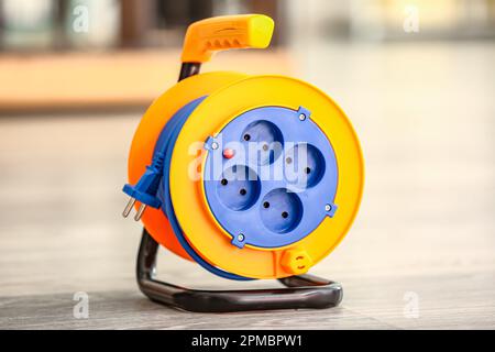 Extension electric cable reel on floor Stock Photo
