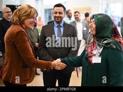 Mainz, Germany. 12th Apr, 2023. Malu Dreyer (SPD, l), Minister President of Rhineland-Palatinate, welcomes Selime Ökden from the Shura Rhineland-Palatinate before breaking the fast in the banquet hall of the Islamic Community of Bosniaks (IGDB) in the presence of Akif Ünal, 1st Chairman Shura Rhineland-Palatinate State Association of Muslims. During the fasting month of Ramadan, the Muslim communities in Rhineland-Palatinate also invite non-Muslims to break their fast in the evening (iftar). Credit: Arne Dedert/dpa/Alamy Live News Stock Photo