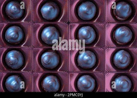 Close up brown chocolate candy background. Assortment of chocolate candies sweets in the box, top view Stock Photo