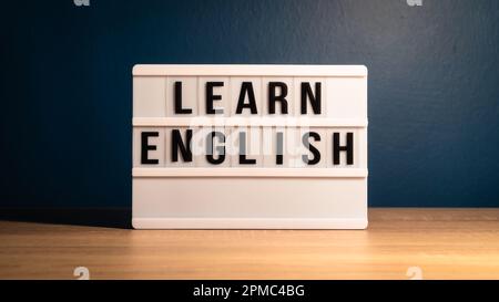 Learning English concept. Learn English message on white letter board. Language learning concept background. Stock Photo