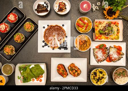 Set of Spanish style healthy food dishes on plates and delivery containers Stock Photo