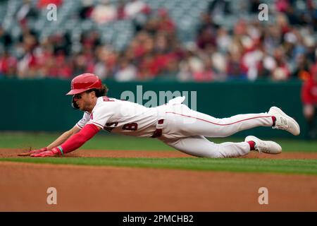 Brett Phillips (L) places a samurai warrior helmet on Los Angeles Angels  teammate Shohei Ohtani to celebrate his home run in the third inning of a  baseball game against the Toronto Blue