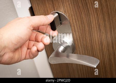 Hand locking or unlocking deadbolt door lock Stock Photo