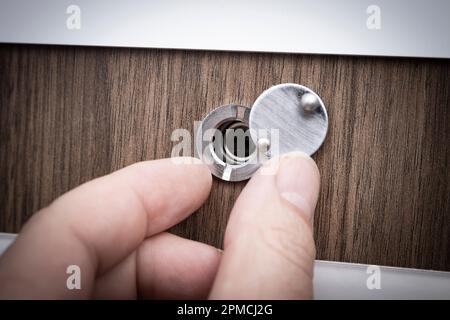 Opening door peephole swivel cover Stock Photo