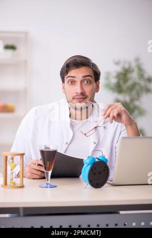 Young chemist examining soft drink at the lab Stock Photo