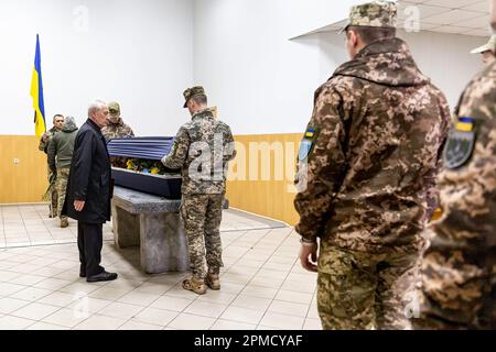 April 12, 2023, Kyiv, Ukraine: Servicemen close a coffin during the funeral of Evgeny Yakovlev, 42, a soldier killed by the Russian forces on eastern Ukrainian front in a combat, at the Lisove Cemetery in Kyiv. Lisove Cemetery is where most of the fallen army-men from Kiev are buried. As the full scale invasion of Ukraine by the Russian forces continuous, the fight in the East of Ukraine causes very high casualty rate, though the exact numbers are unknown. Ukraine prepares for a spring offensive to retake the land occupied by Russia. (Credit Image: © Dominika Zarzycka/SOPA Images via ZUMA Pres Stock Photo