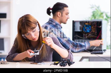 The two technicians working at computer warranty center Stock Photo