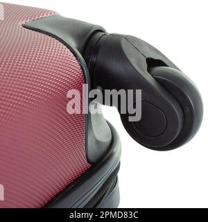 Black wheel of purple travel bag isolated on white background close-up Stock Photo