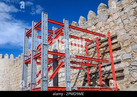 Structural reinforcement scaffolding framework using steel girders for work on repair and preservation of ancient castle walls, Avila, Spain, Europe Stock Photo