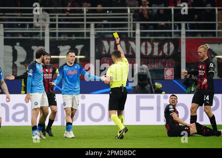 Istvan Kovacs (Referee) shows the yellow card to -Piotr Zielinski (SSC Napoli) during the UEFA Champions League, Quarter-finals, 1st leg football match between AC Milan and SSC Napoli on April 12, 2023 at San Siro stadium in Milan, Italy - Photo Luca Rossini / E-Mage Stock Photo