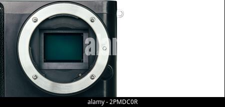 Close up macro of APS-C Sensor and lens mount on digital mirrorless camera for image recorder on white background, banner with copy space. Stock Photo