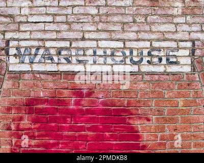 unique old warehouse sign on brick building Stock Photo
