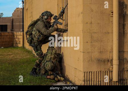 A Dutch Marine with Marine Squadron Carib, Netherlands Marine Corps climbs through a window during Exercise Caribbean Urban Warrior on Camp Lejeune, North Carolina, March 31, 2023. Exercise Caribbean Urban Warrior is a bilateral training evolution designed to increase global interoperability between 2d Marine Division and Marine Squadron Carib. (U.S. Marine Corps photo by Lance Cpl. Ethan Miller) Stock Photo