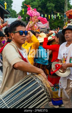 Pai,Northern Thailand-April 4th 2023: Super energetic post Covid festivities abound in the passing crowd,at the colorful Buddhist festival,where boys Stock Photo