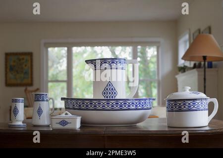 Antique blue and white toilet set with toothbrush holder, small pitcher, soap dish, large jug in wash basin and chamber pot, used in the early 1900s. Stock Photo