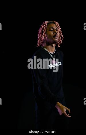 Atlanta Rapper SoFaygo perform on stage at Scotiabank Arena in Toronto with pink hair, a diamond watch, jewel medallion and a Mickey Mouse neck tattoo Stock Photo