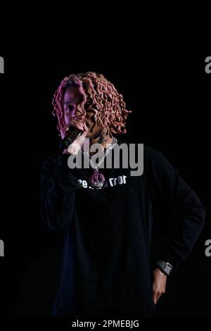 Atlanta Rapper SoFaygo perform on stage at Scotiabank Arena in Toronto with pink hair, a diamond watch, jewel medallion and a Mickey Mouse neck tattoo Stock Photo