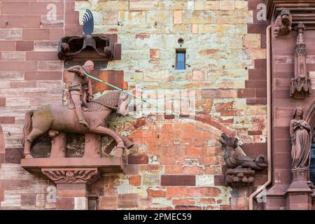 The legend Saint George is fighting against a dragon monster on the exterior wall of the Basel cathedral Stock Photo