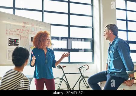 Creatives in action. designers brainstorming on a whiteboard in an office. Stock Photo
