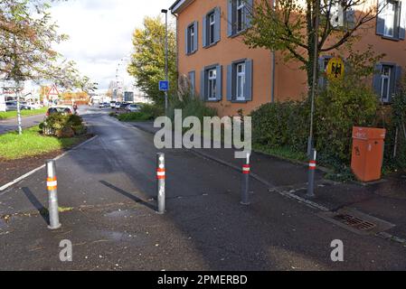 A small sign and an open road with just bollards to mark the border line on the Swiss German border in Konstanz, Nov 2022 Stock Photo
