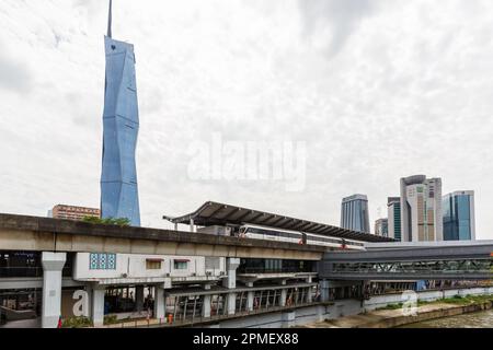 Kuala Lumpur, Malaysia – February 5, 2023: Metro LRT train of Kelana Jaya Line at Pasar Seni station and skyscraper Merdeka PNB 118 Tower in Kuala Lum Stock Photo