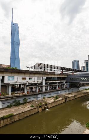 Kuala Lumpur, Malaysia – February 5, 2023: Metro LRT train of Kelana Jaya Line at Pasar Seni station and skyscraper Merdeka PNB 118 Tower portrait for Stock Photo