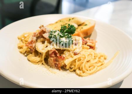 bacon spaghetti, spaghetti carbonara or pasta or pasta carbonara and garlic bread Stock Photo