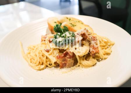 bacon spaghetti, spaghetti carbonara or pasta or pasta carbonara and garlic bread Stock Photo