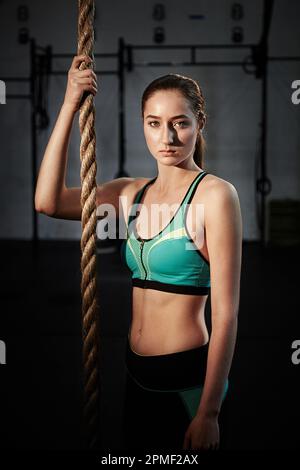 Push yourself, its so worth it. a young woman doing rope climbing. Stock Photo