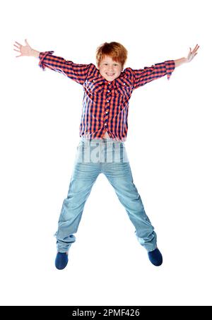Bouncing boys. Studio shot of a young boy jumping for joy against a white background. Stock Photo