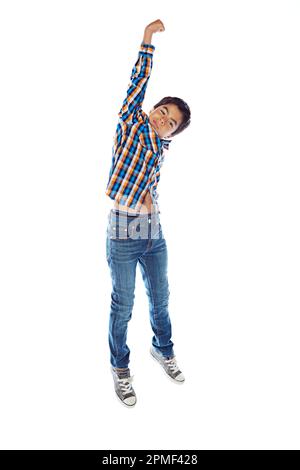 Way to grow. Studio shot of a young boy jumping for joy against a white background. Stock Photo