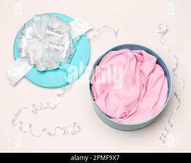 Open large round gift box with satin insert. Close-up, top view Stock Photo