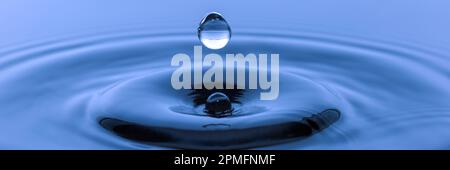 single water drop falling down to surface Stock Photo
