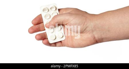 Men's hand holding white pills in common tablets shape isolated on white background. Hand with pills, closeup Stock Photo