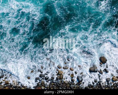 Aerial View to Ocean Waves. Blue Water Background. Top View of Foaming Blue Ocean Waters. Stock Photo