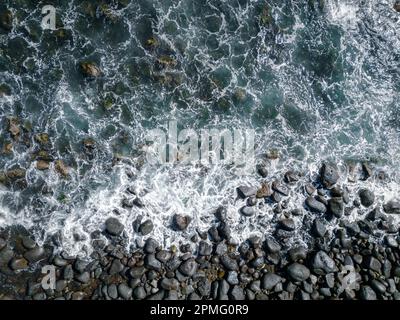 Aerial View to Ocean Waves. Blue Water Background. Top View of Foaming Blue Ocean Waters. Stock Photo