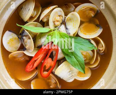 Steamed clams or clam soup cooked in vietnamese style isolated on black background top view Stock Photo