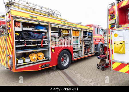 April 2023 - Open side of a modern fire engine showing its kit at the Pageant of Motoring on the Lawns at Weston super Mare, in North Somerset, UK. Stock Photo