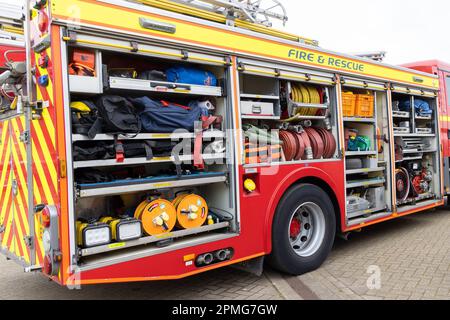 April 2023 - Open side of a modern fire engine showing its kit at the Pageant of Motoring on the Lawns at Weston super Mare, in North Somerset, UK. Stock Photo