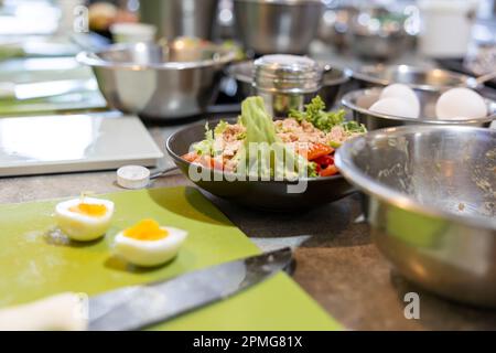 Canned tuna in bowl with fresh vegetables salad, lemongrass, tomato, lemon, red chili pepper, onion Stock Photo